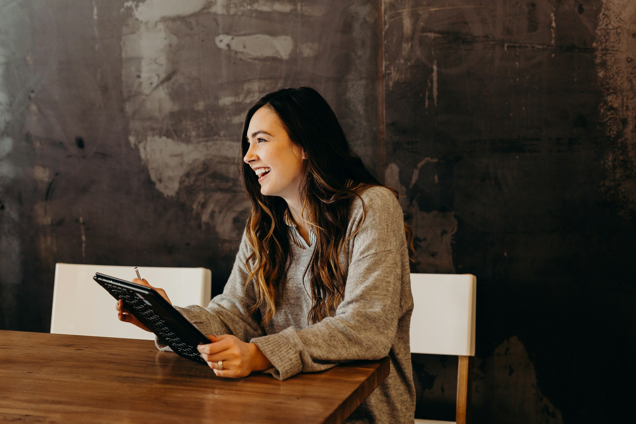 Business owner reviewing plans on a tablet at a table