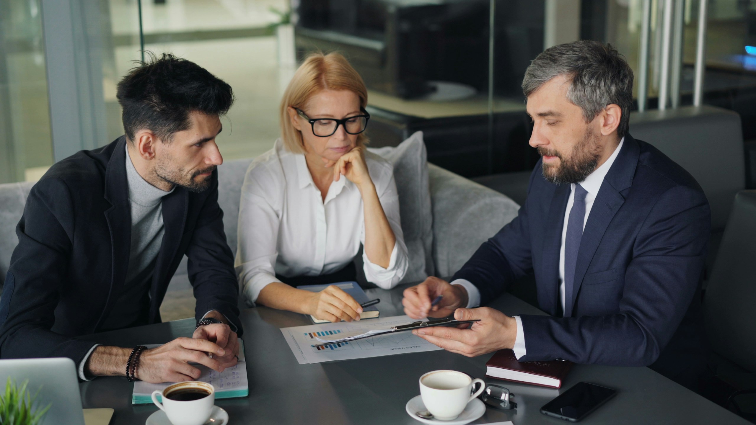 Business leaders discussing a plan around a table