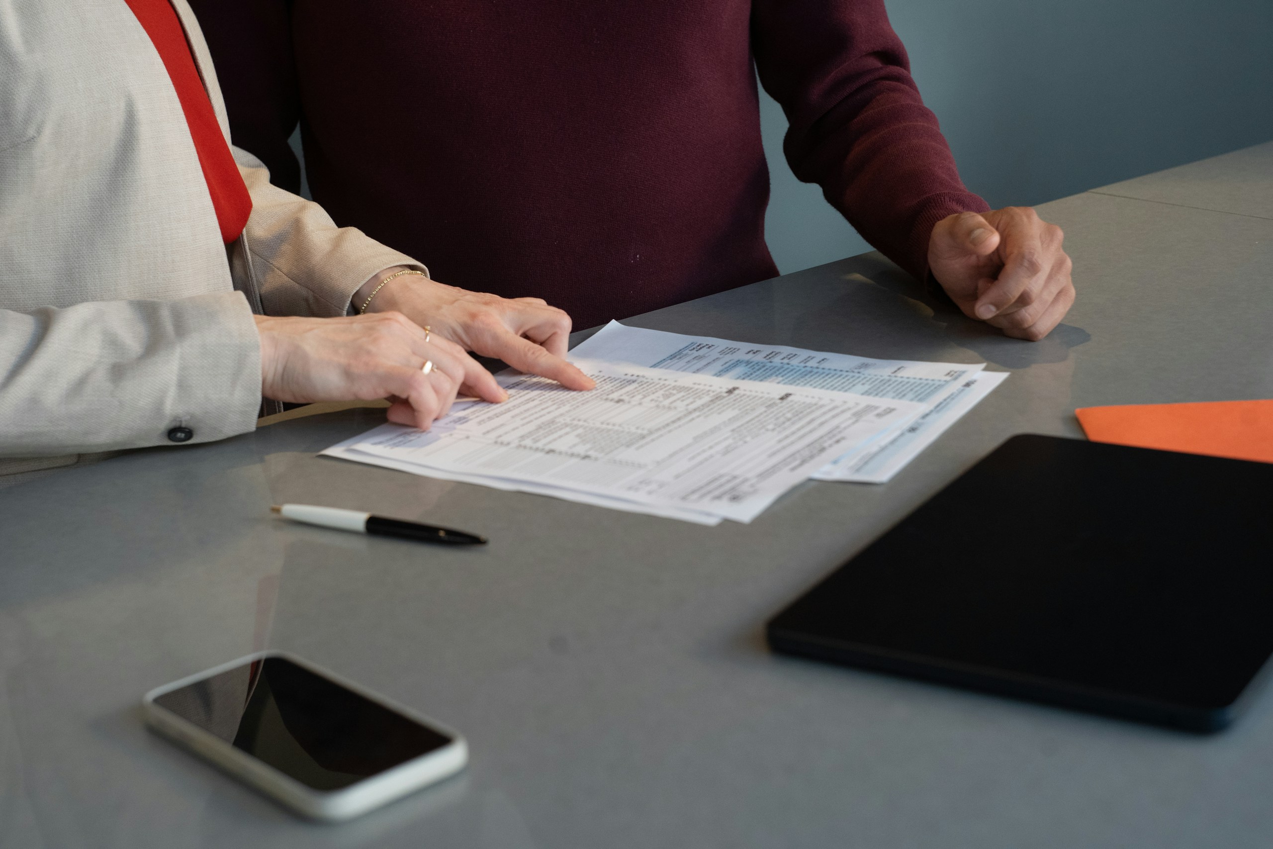 Reviewing and comparing policy paperwork at a table