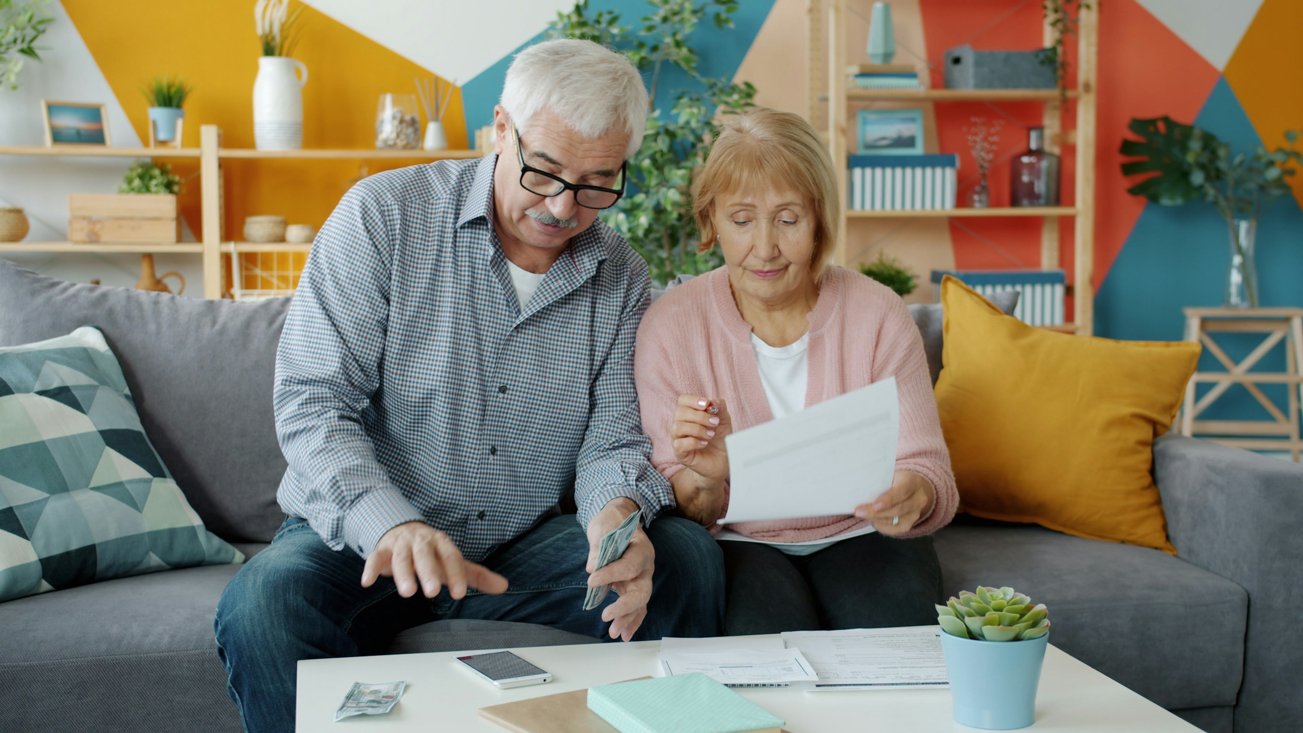 Senior couple reviewing financial documents together at home