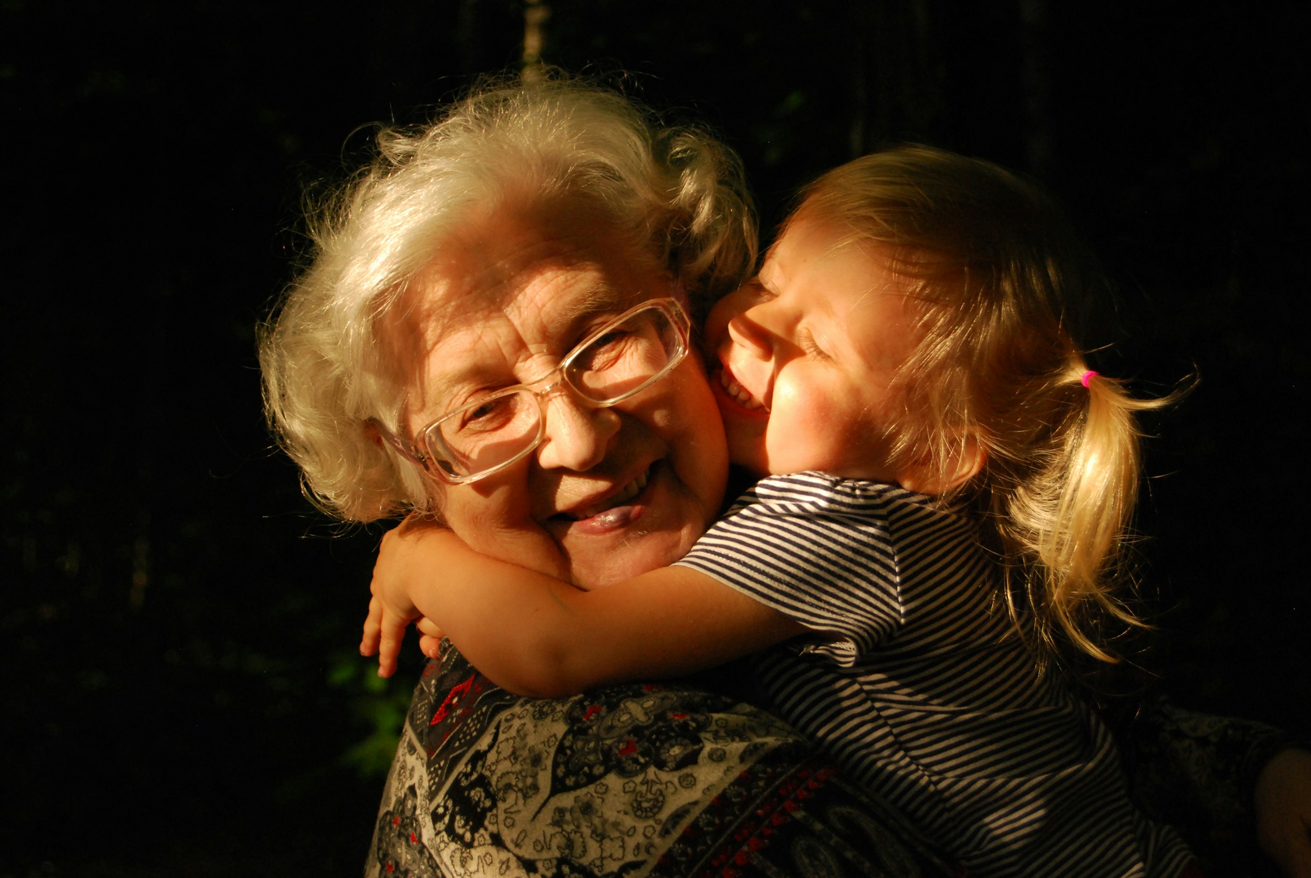 Grandmother hugging her young grandchild